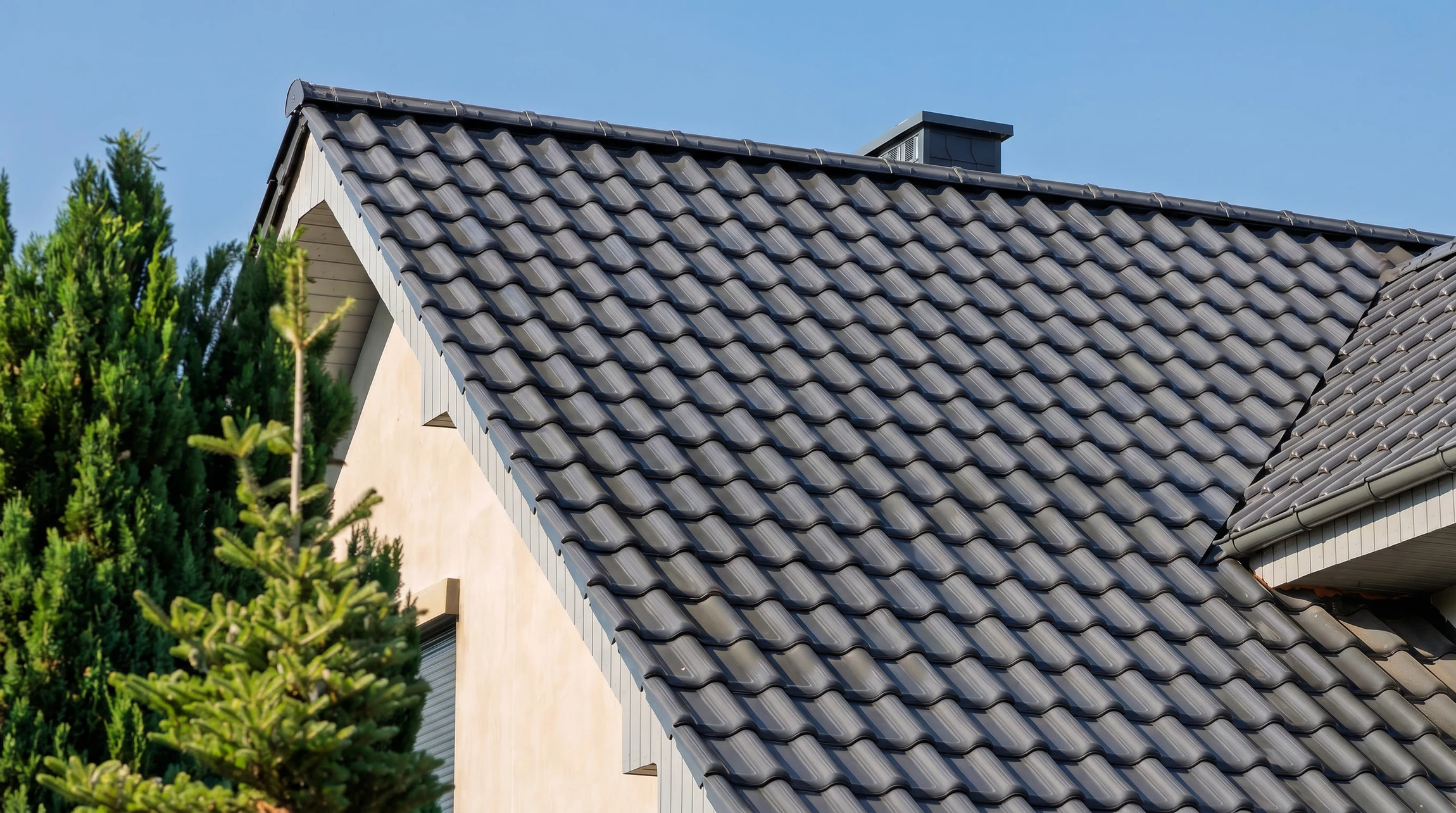 Chantier de construction extérieur avec ouvrier installant une charpente en bois sur maison à ossature bois